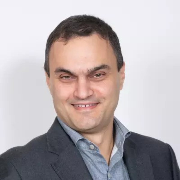 Headshot of a man, wearing a business suit.