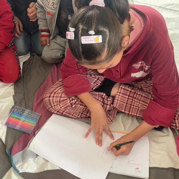Young girl in Gaza drawing a picture.