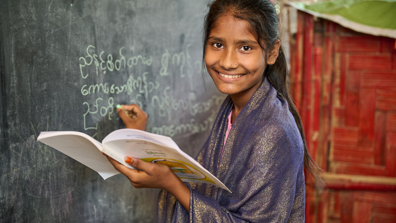 Girl writing on blackboard