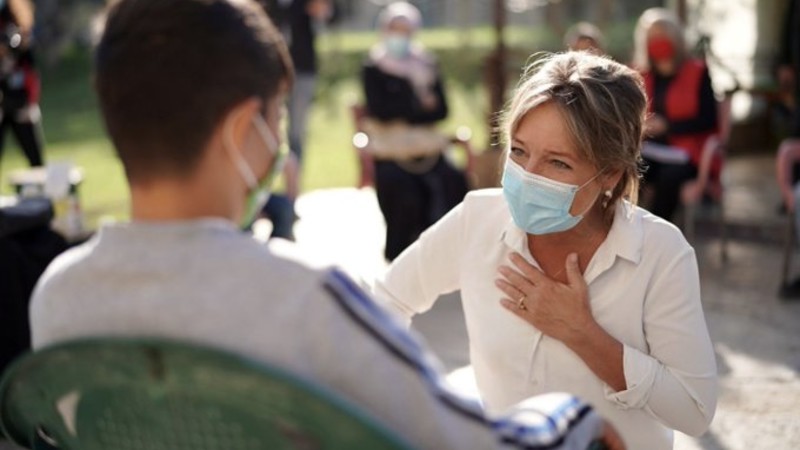ECW Director Yasmine Sherif with a child in Lebanon