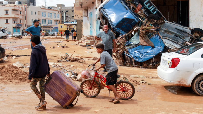 Child rides his bike during flooding in Libya.