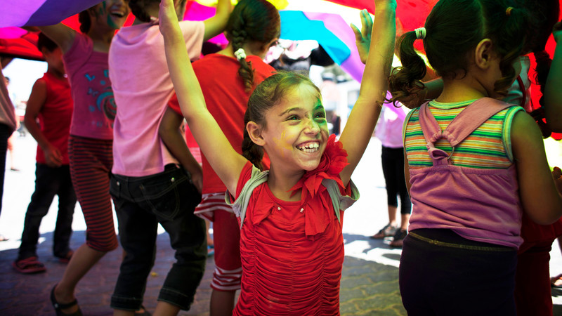 Girl smiling and raising her arms