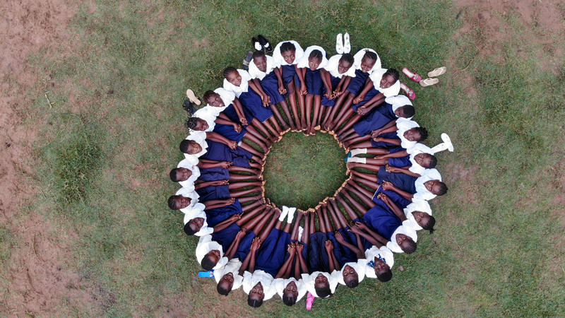 Girls seated in a circle in the DRC.