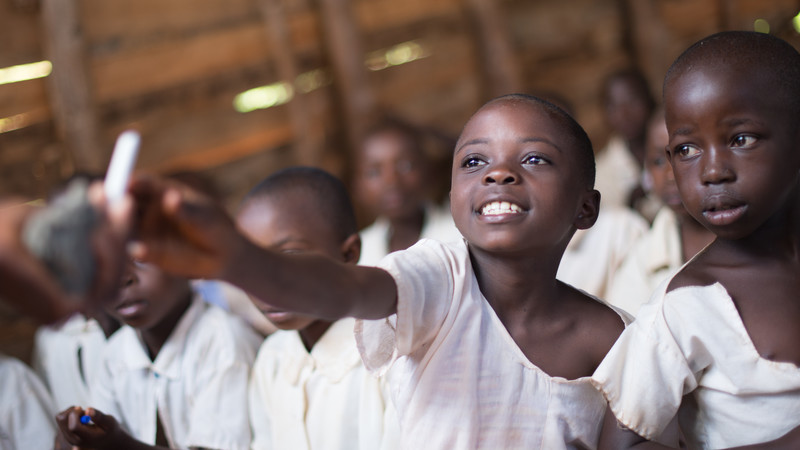 Child in classroom in Uganda
