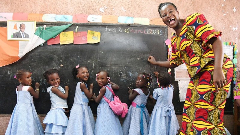 Teacher with schoolgirls in a classroom