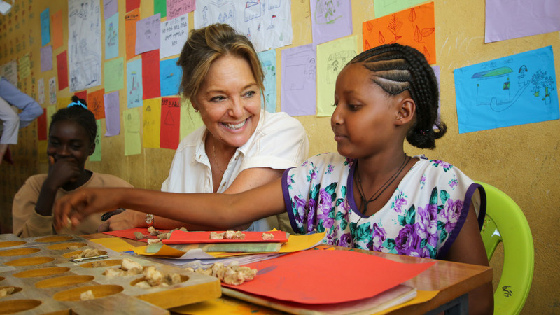 Yasmine Sherif interacting with a child in Ethiopia