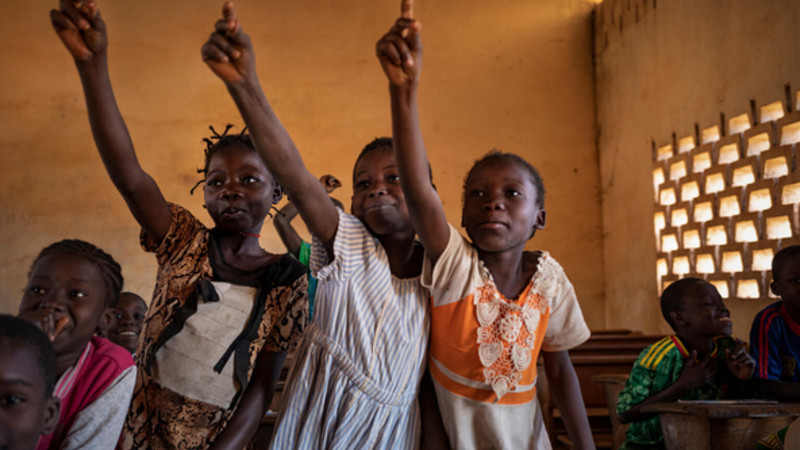 Children raising their hand in a classroom in CAR