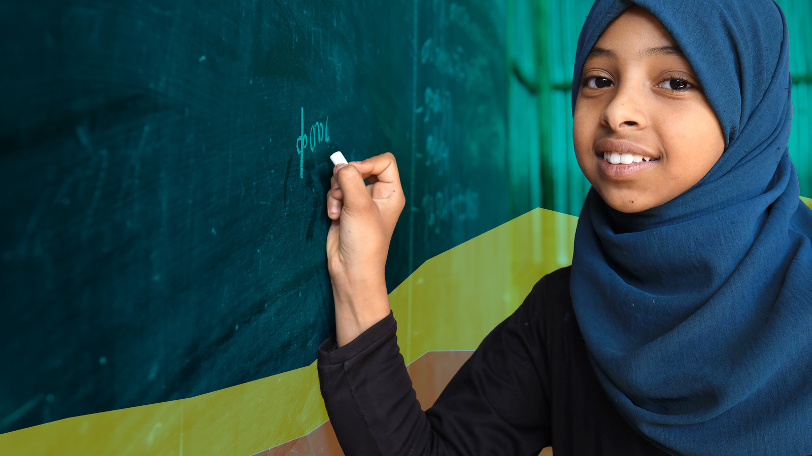 Girl writing on blackboard