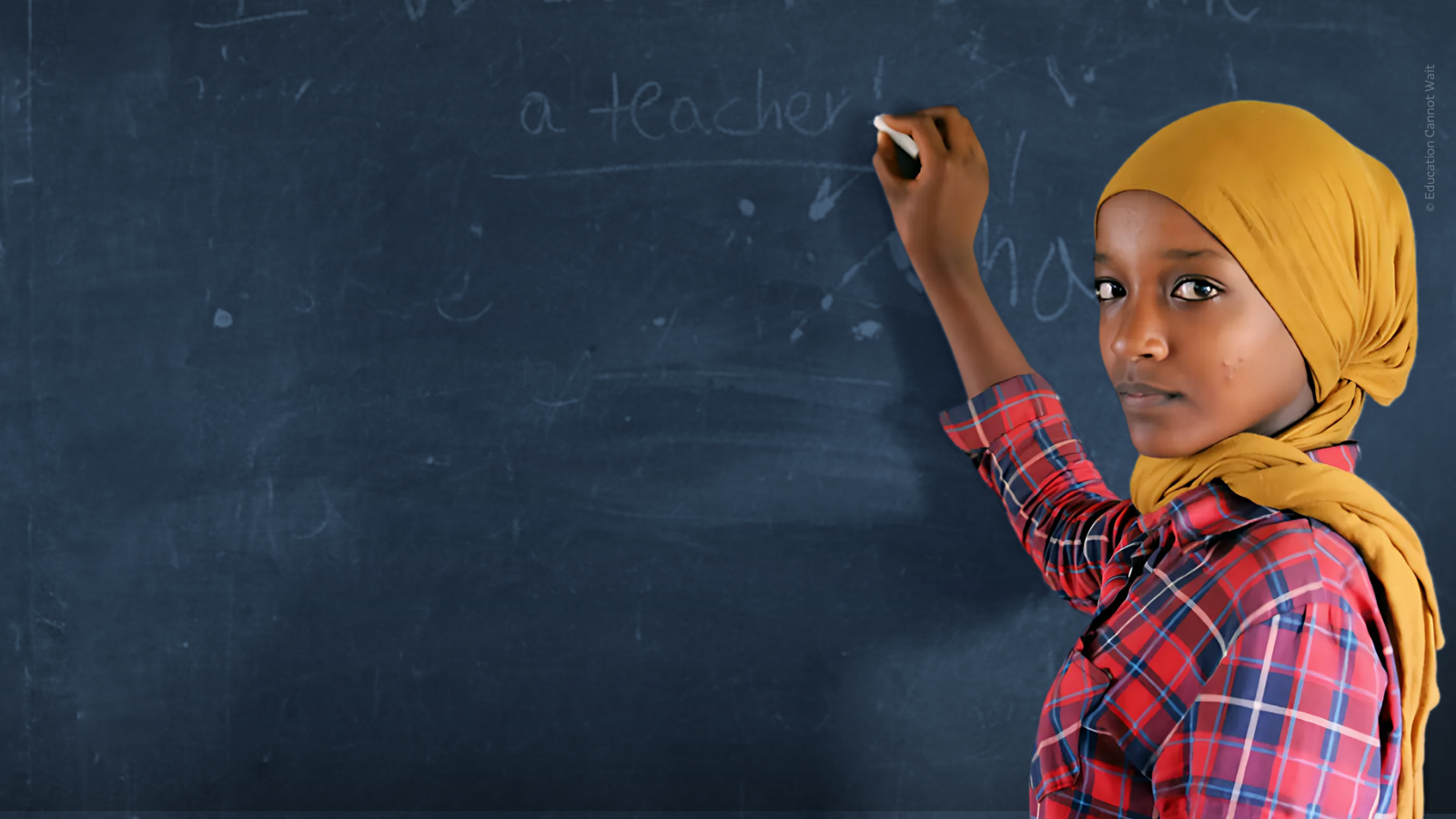 Girl writing on blackboard