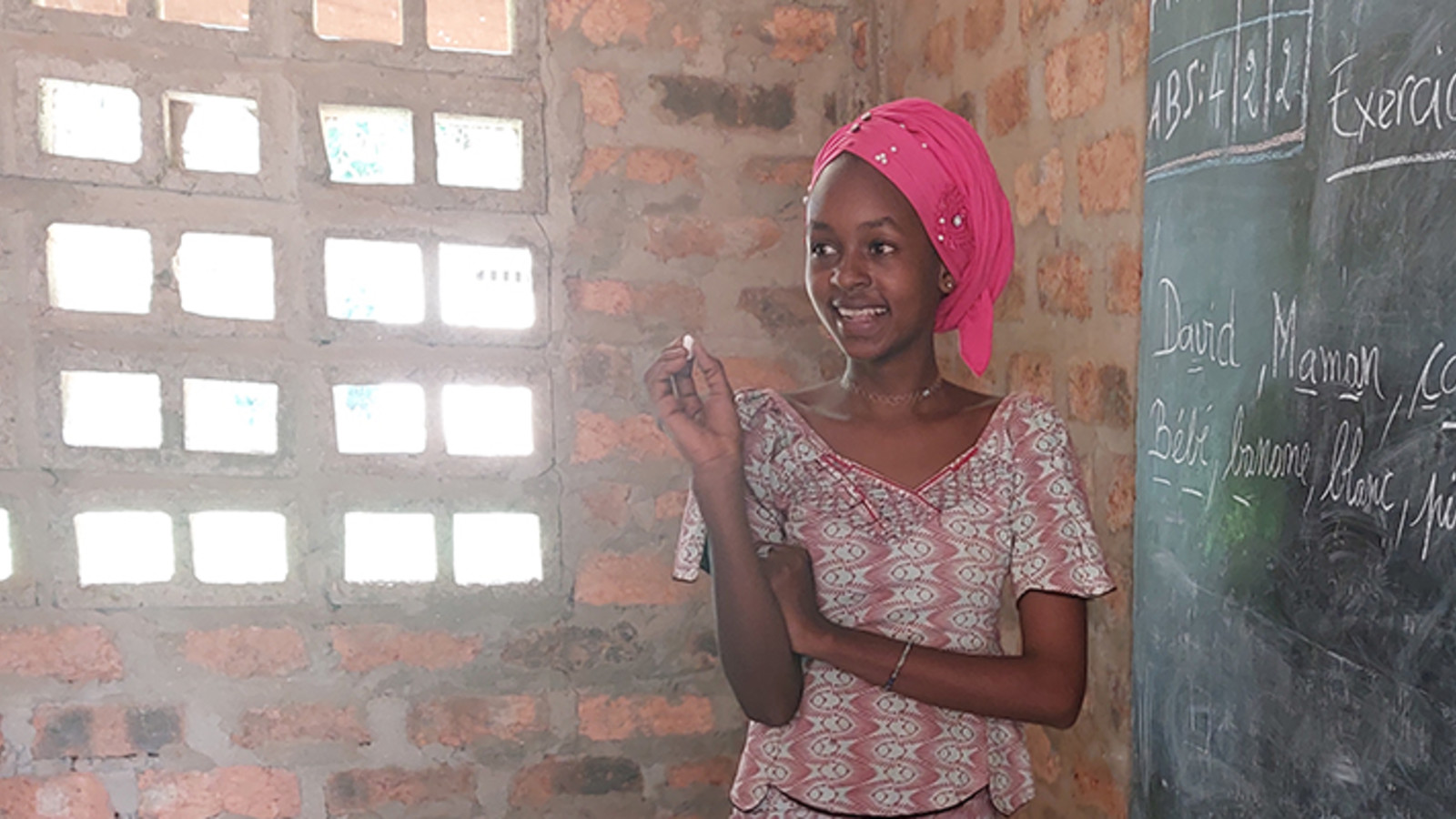 Girl writing on blackboard