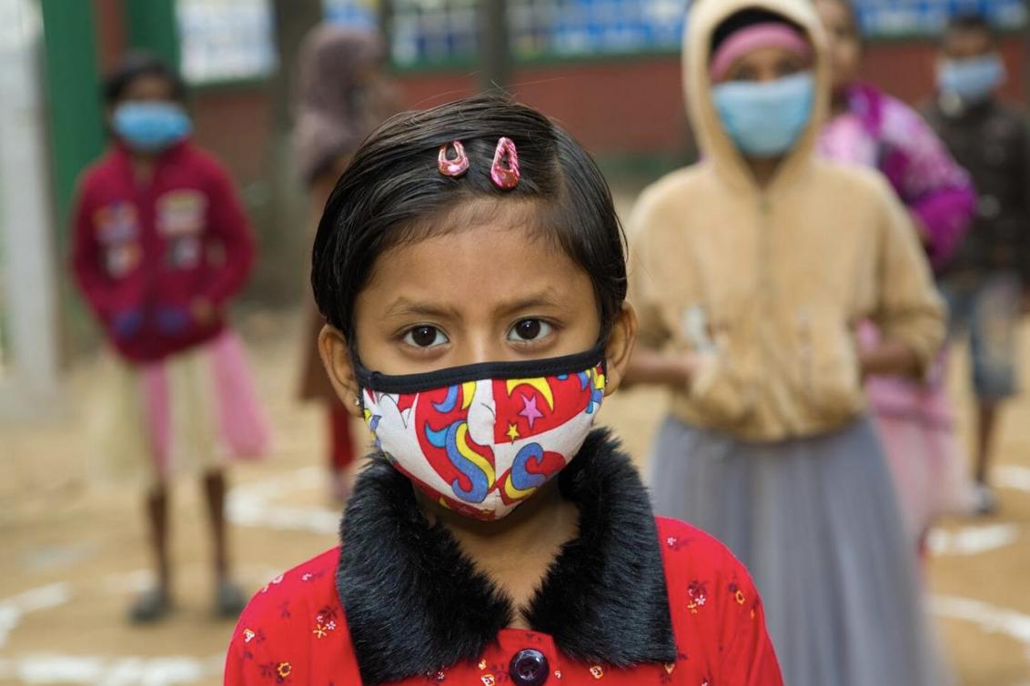 Girl wearing a facemask looking to the camera
