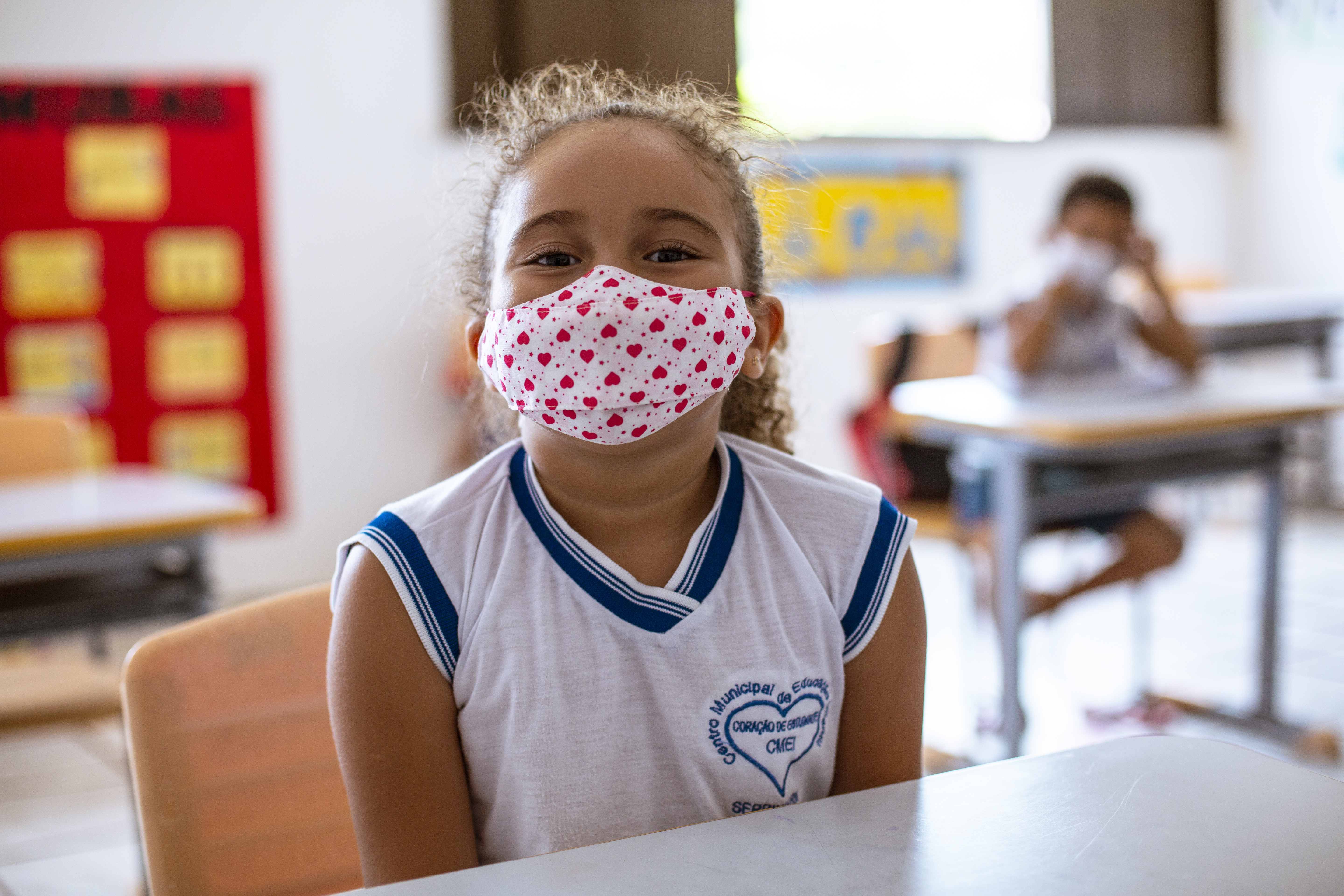 Girl in classroom wearing a mask