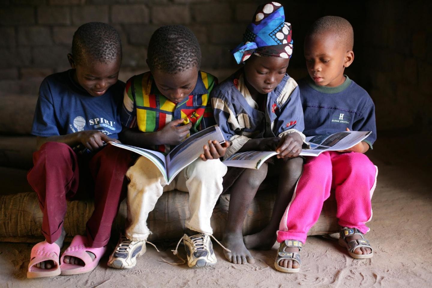 Groups of children sitting down reading books