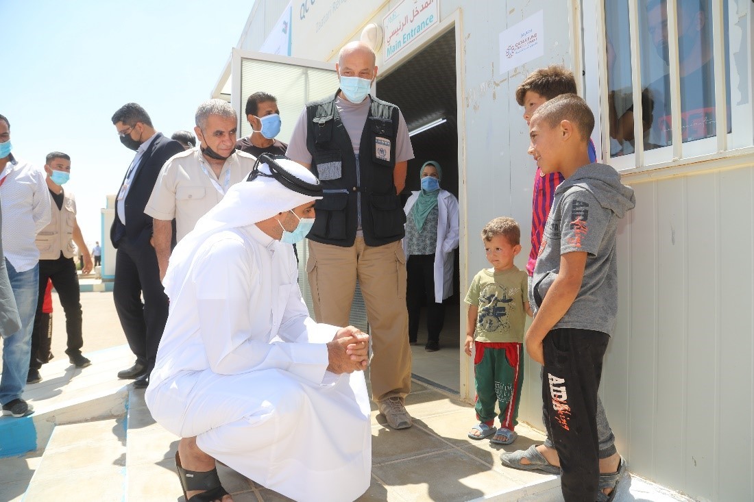 Mr. Al-Kuwari speaking with children.