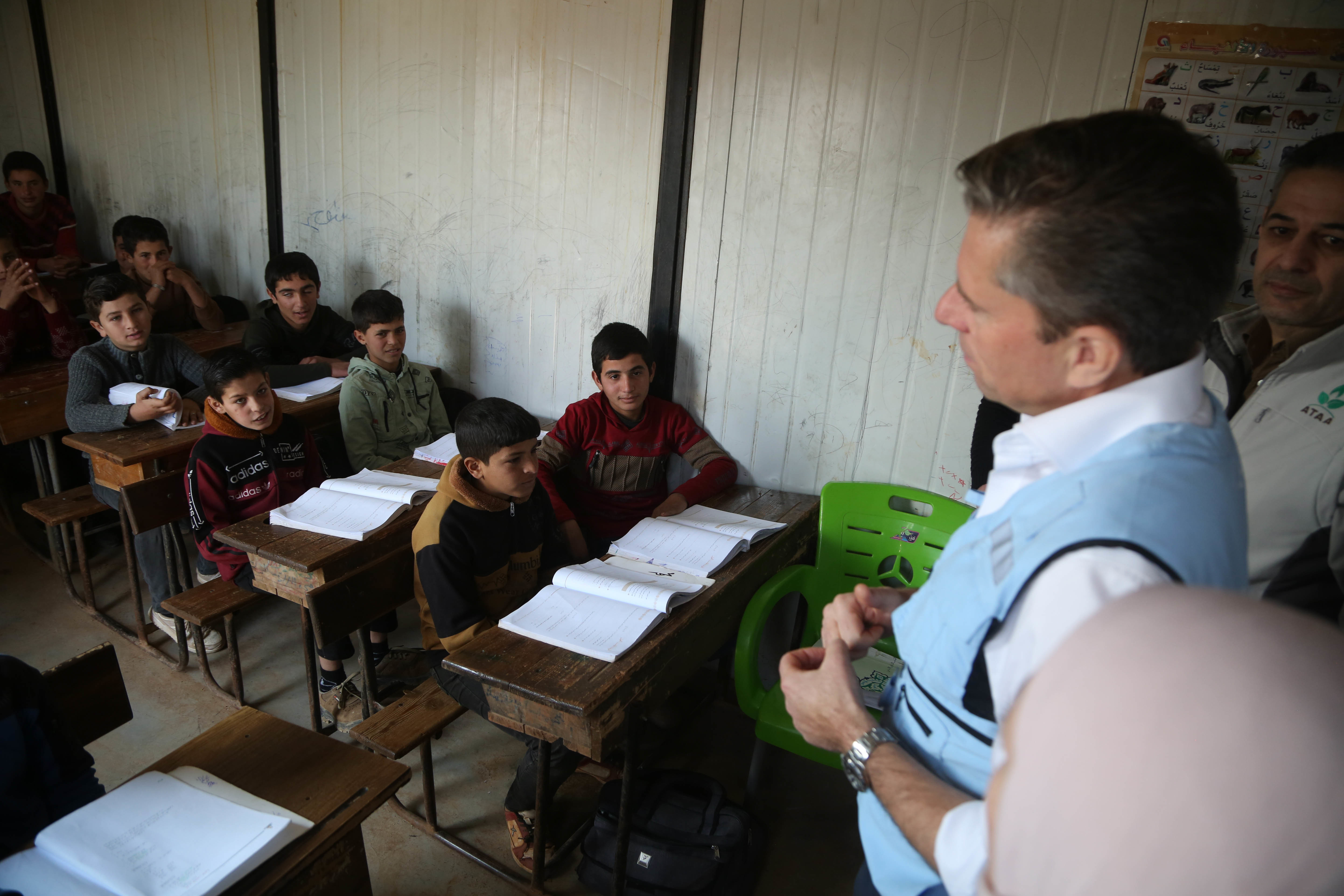 Tom Fletcher interacting with children in a classroom